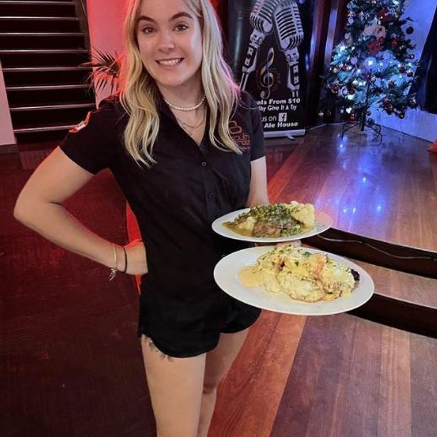 Restaurant staff happily serving food