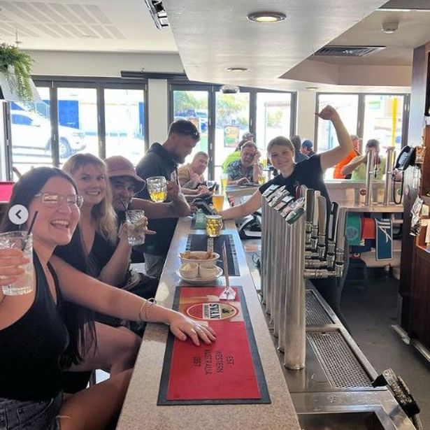 Group of people cheering and enjoying their drinks