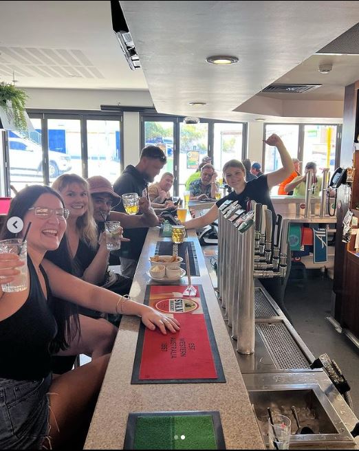 Group of people cheering and enjoying their drinks